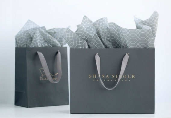 Custom branded photography studio gift bags in slate gray with tissue paper for professional print delivery