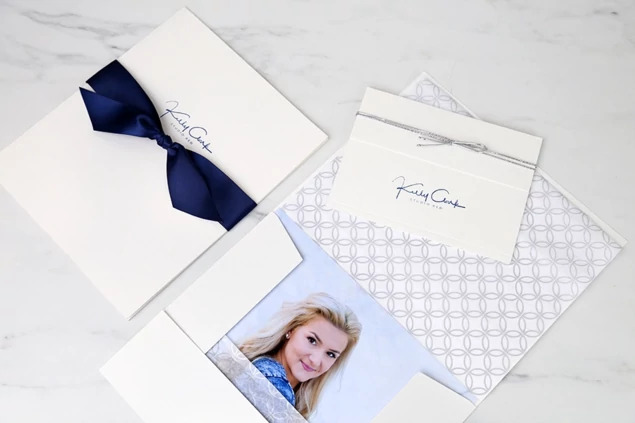 White Tyndell Photo Case styled with ribbon and tissue paper accessories for complete portrait delivery