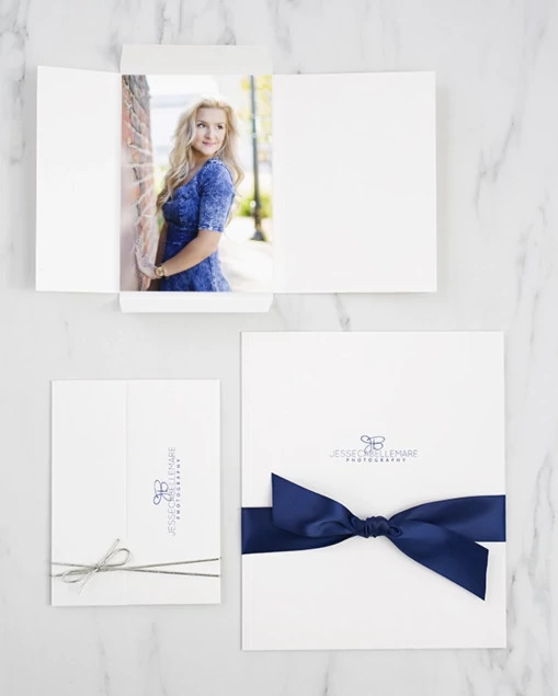 White Tyndell Photo Case open showing scored edge folded out to expand carrying capacity for multiple prints
