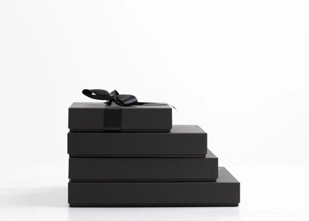 Four stacked matte black square presentation boxes in graduating sizes     Tyndell square presentation box collection