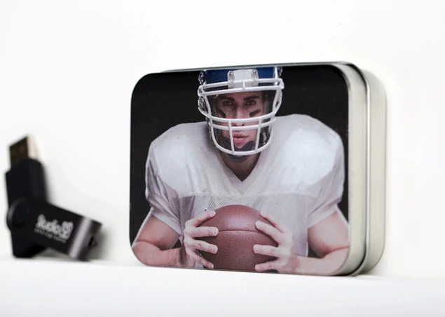 Metal tin box open with Credit Card flash drive in foam insert showing wallet size tin packaging