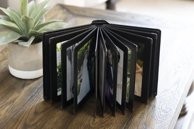Camden Album open showing multiple slip-in pages fanned out with portrait images