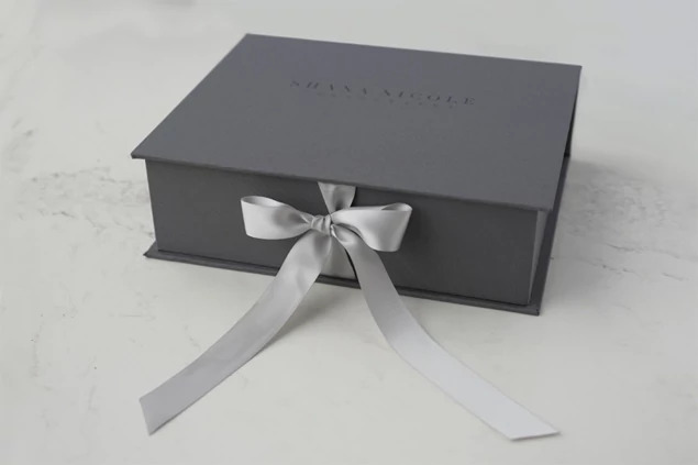 Tyndell Portfolio Box styled for fine portrait delivery showing ribbon tie and fabric finish detail