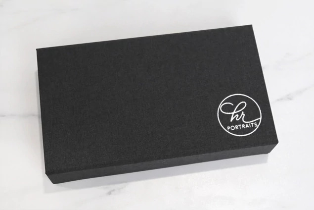 Carbon fabric flash and print box closed showing foil imprinted studio logo on lid