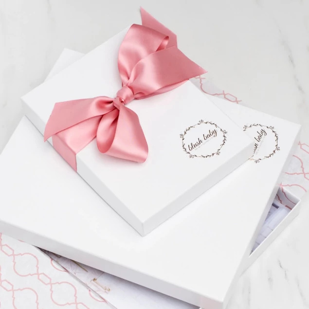White leather portrait box with custom foil imprinted studio logo and pink satin ribbon     Tyndell portrait packaging