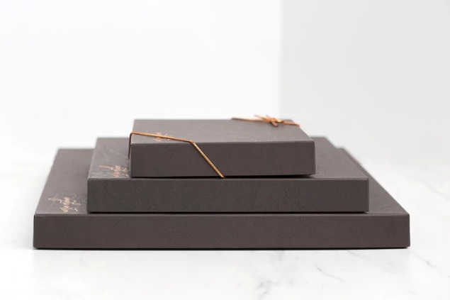 Black leather portrait box closed with custom foil imprinted studio logo     Tyndell portrait packaging