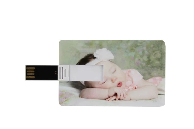 White credit card flash drive with full-color newborn portrait printed on front showing hinged USB design