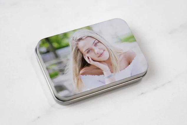 Metal tin boxes shown together displaying multiple full color printed lid design options