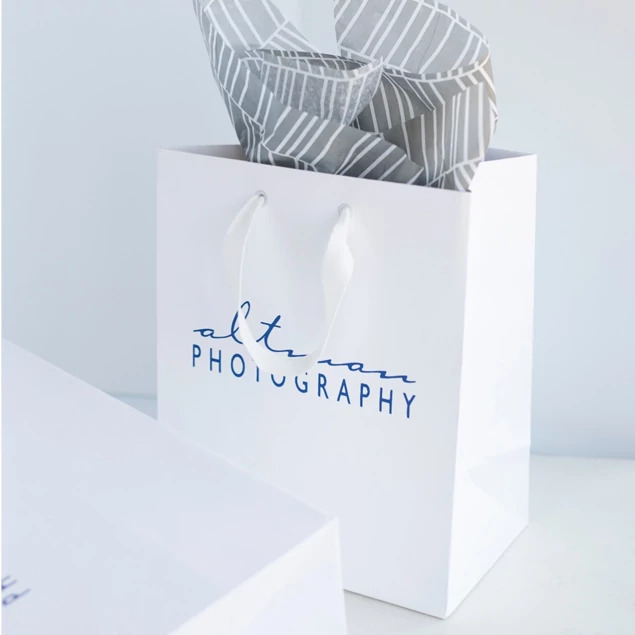 White Euro Tote bag close-up showing foil imprinted studio logo and clean white paper construction