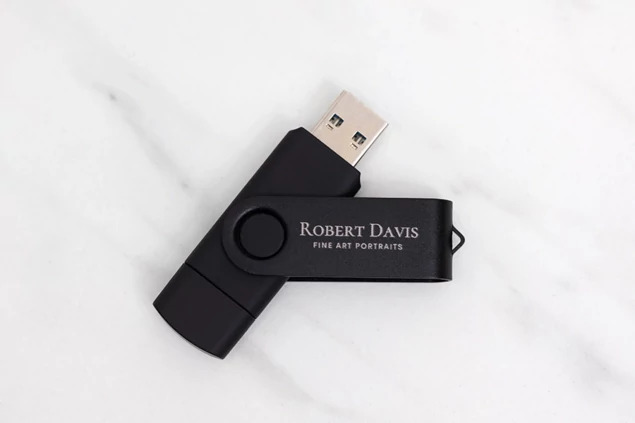 Black dual swivel flash drive showing USB-C connector extended for Apple and modern device compatibility