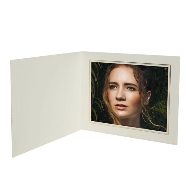 White Cal Folder open with one portrait photo, showing linen finish and gold foil border