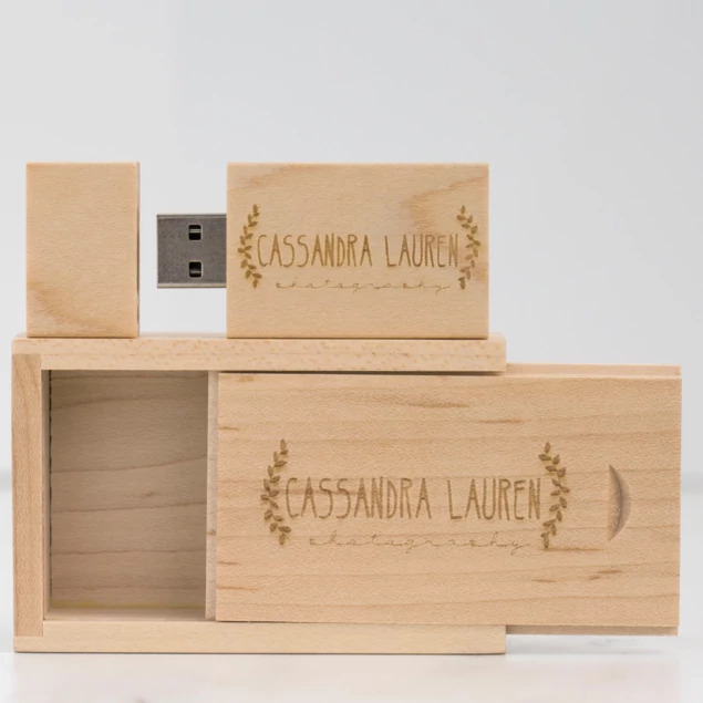 Tyndell Walnut Wood Flash Drive with full color printed studio logo showing customization on walnut wood surface