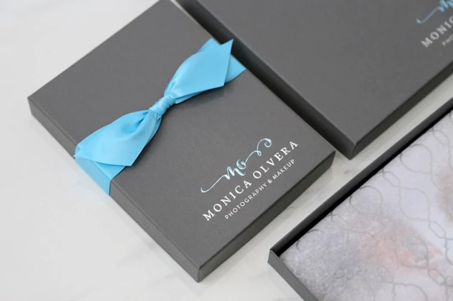 Slate portrait box open with teal ribbon showing white interior     Tyndell portrait box