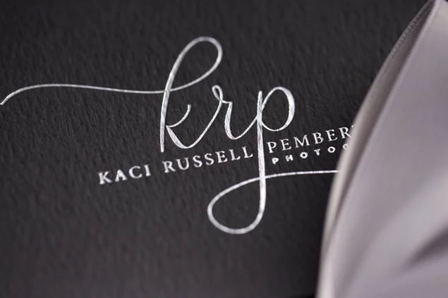 Black Tyndell Photo Case showing foil imprinted studio logo on black linen texture surface