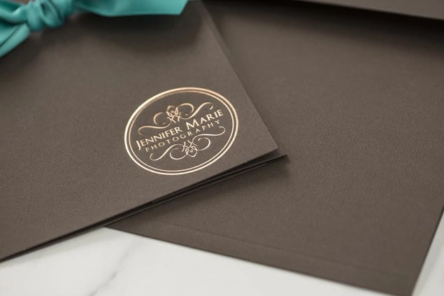 Chocolate Tyndell Photo Case showing foil imprinted studio logo on chocolate linen texture surface