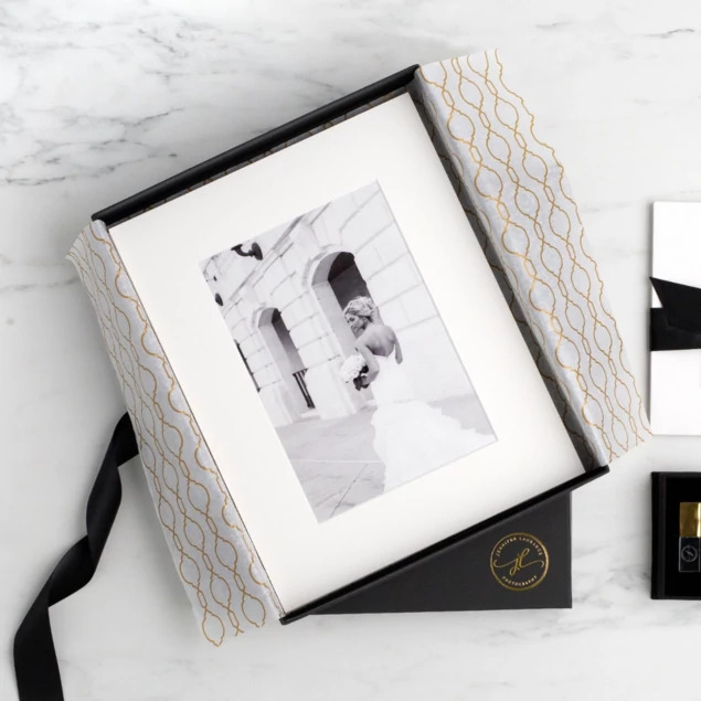 Open matte black presentation box with portrait print and portfolio mat inside     Tyndell portrait packaging