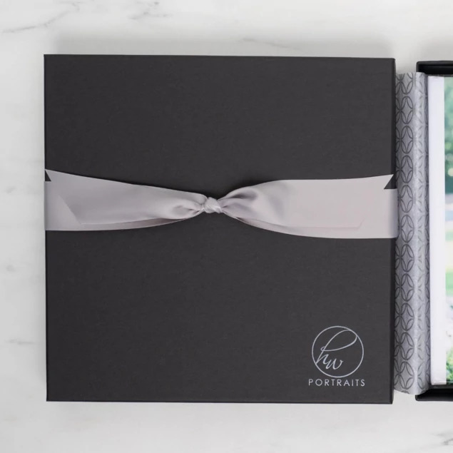 Square Photo Book Boxes in Matte Black and Slate showing 8x8, 10x10, and 12x12 sizes with raised lid design
