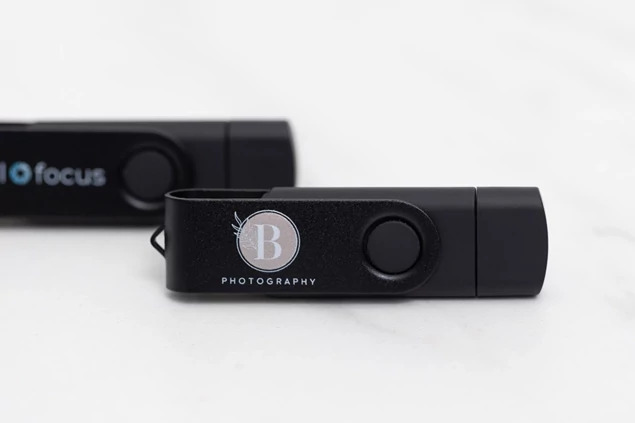Black dual swivel flash drive closed showing both connector ends and compact swivel design