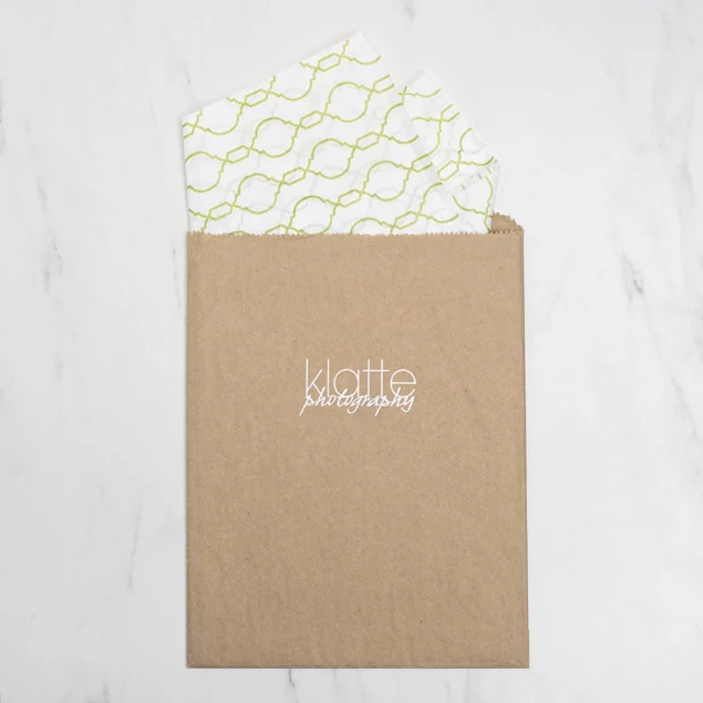 Natural kraft flat paper merchandise bags for studio photo delivery showing open top design