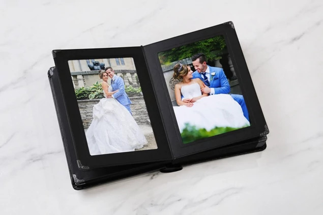 Camden Album open displaying wedding portrait with black gilded pages and slip-in side loading design
