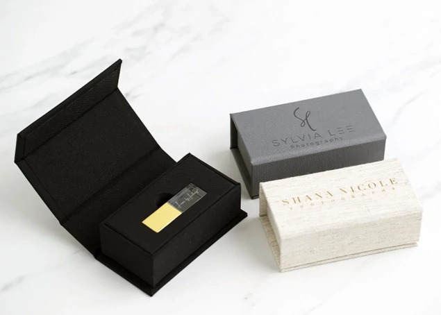 Luxe Fabric USB Boxes in Black, Slate, and Linen showing linen-like fabric exterior and hinged magnetic closure