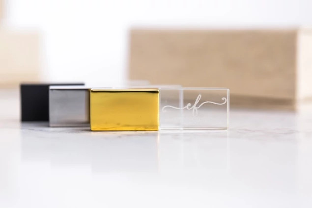 Crystal flash drives in Black, Gold, and Silver shown together highlighting cap color options
