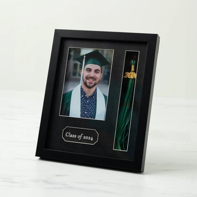 Tyndell Tassel Frame in 5x7 showing black wood frame with white border holding portrait, graduation year, and tassel