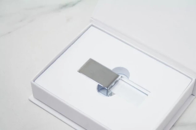 White Magnetic USB Gift Box closed with engraved studio branding on smooth white lid