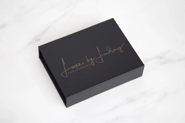 Black Magnetic USB Gift Box closed with engraved studio branding on textured black lid