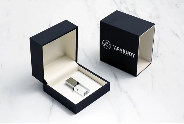 Crystal flash drives in Rose Gold, Gold, Silver, and Black caps shown with Luxe Soft Touch Black USB Box