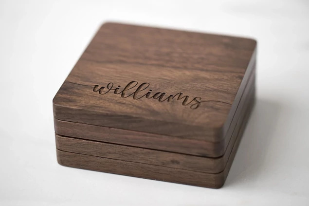 Tyndell Walnut Wood Coaster close-up showing laser engraved name and date on natural walnut grain