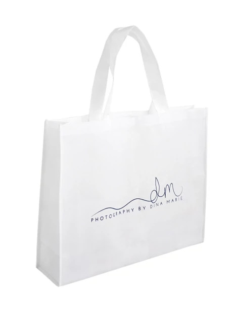 White frame bag close-up showing nonwoven fabric construction and reinforced shoulder handles