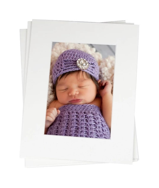 Archival portfolio mat displaying newborn portrait in soft white linen finish     Tyndell newborn photography mat