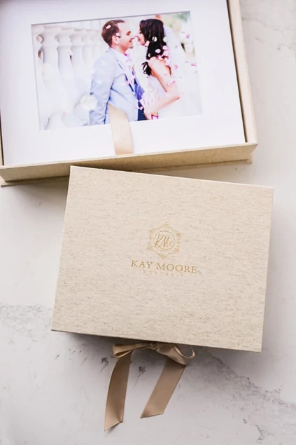 Archival portfolio mat displaying wedding portrait next to wooden USB box     Tyndell portrait presentation mat