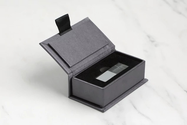 Slate fabric USB box open showing black velvet insert designed to hold one Crystal Flash Drive