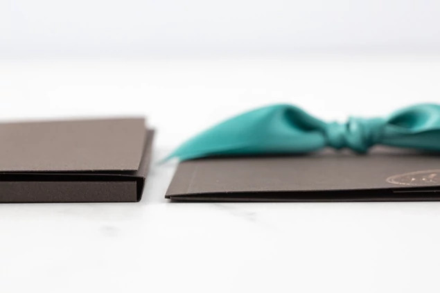 Chocolate Tyndell Photo Case styled with ribbon and tissue paper accessories for complete portrait delivery