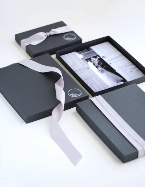 Open matte black portrait box with white ribbon showing interior depth     Tyndell portrait box