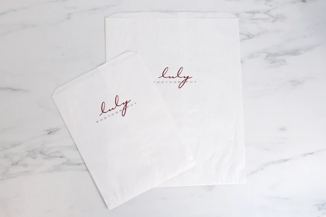 White flat paper bags stacked showing clean white construction and open top design