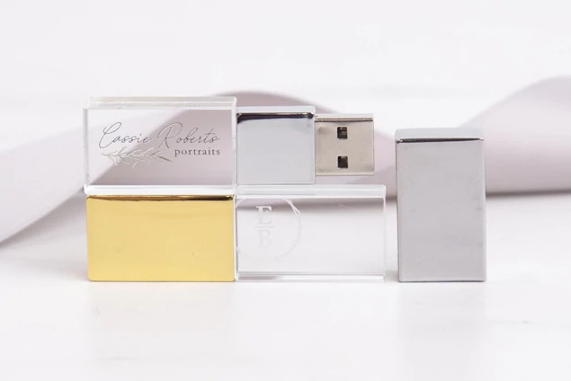 Gold and Silver cap crystal flash drives shown side by side on white surface