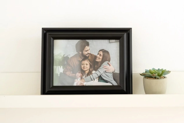 Black Wood Frame on shelf with family portrait in horizontal orientation     solid wood black frame with glass front