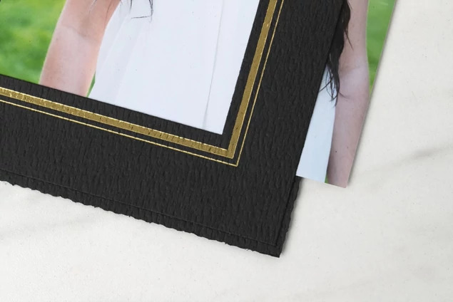 Titan Folder with holiday foil imprinting showing seasonal design on black linen texture cover