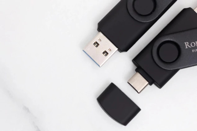 Black dual swivel flash drives shown together displaying full color custom printed branding on drives