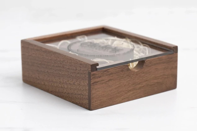 Tyndell Walnut Wood Flash Drive Box with acrylic top showing full color printed studio logo on clear acrylic lid