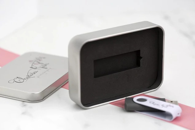 Tyndell USB Swivel Drive and Metal Tin Bundle showing tin lid with full color printed studio logo