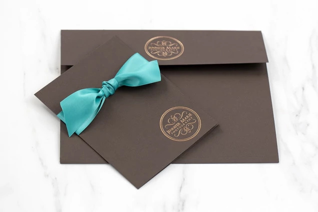 Chocolate Tyndell Photo Case open showing scored edge folded out to expand carrying capacity for multiple prints