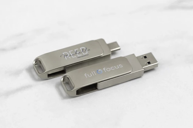 Dual metal flash drive with USB-C connector extended showing full color printed branding on drive