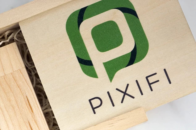 Rustic wood flash drive box closed showing engraved studio logo on natural wood lid