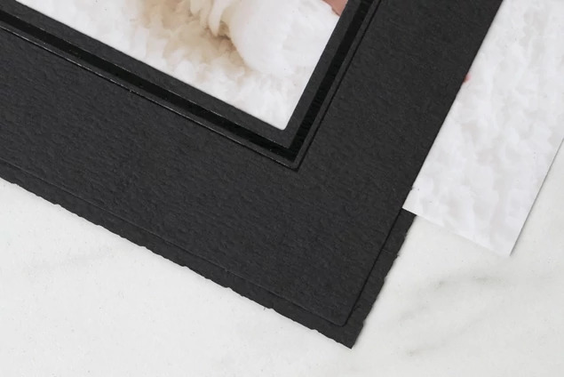Onyx Folder open showing slip-in side loading design with single print slot and black foil border