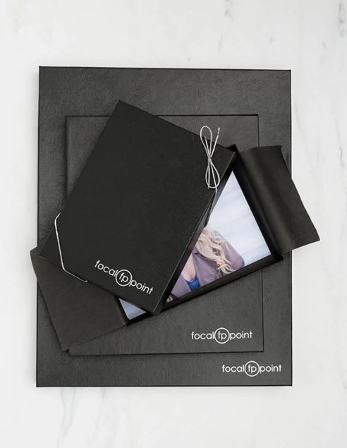  Black leather portrait box closed with custom foil imprinted studio logo     Tyndell portrait packaging
