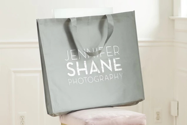 Slate gray frame bag with screen printed studio logo showing branding option on nonwoven bag